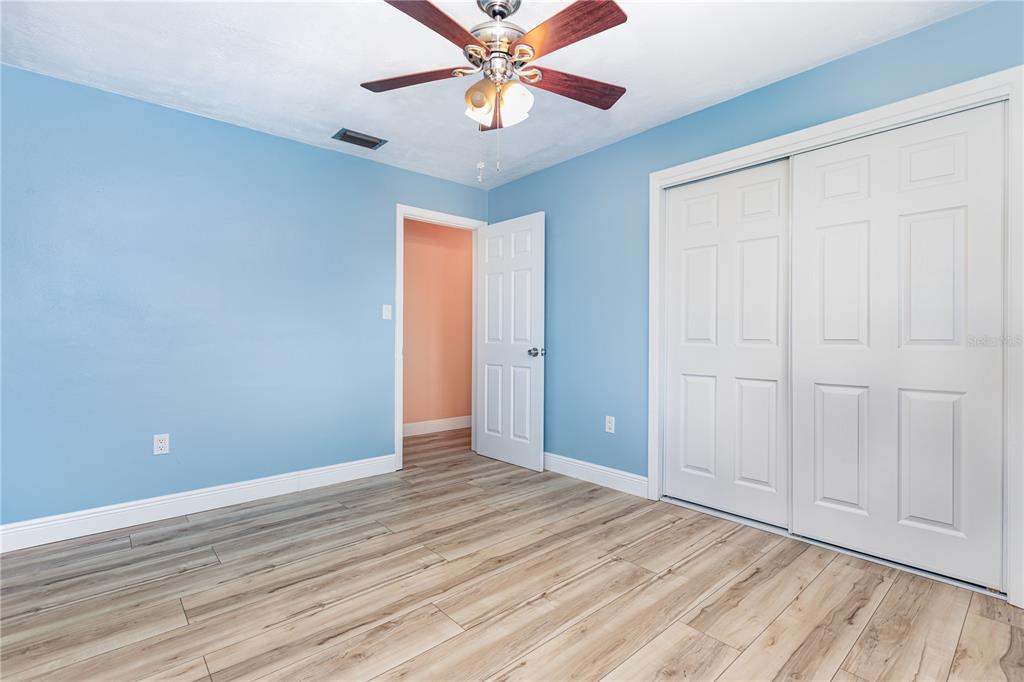 5108 Commonwealth Road Palmetto, FL 34221 - Photo 12 of 31 a view of an empty room with window and wooden floor