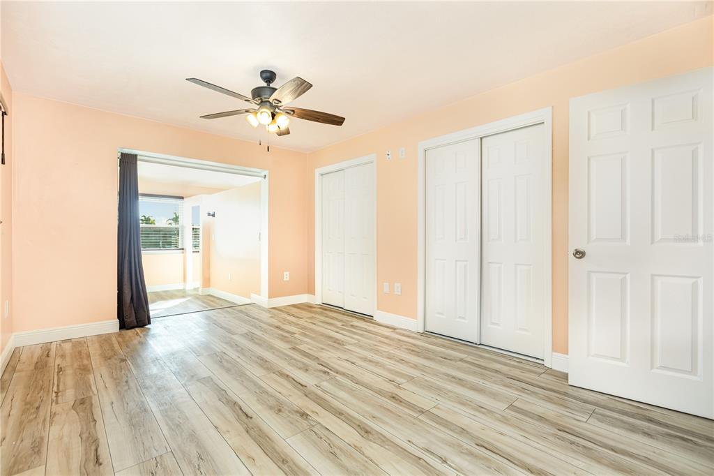 5108 Commonwealth Road Palmetto, FL 34221 - Photo 14 of 31 a view of a room with wooden floor and a ceiling fan
