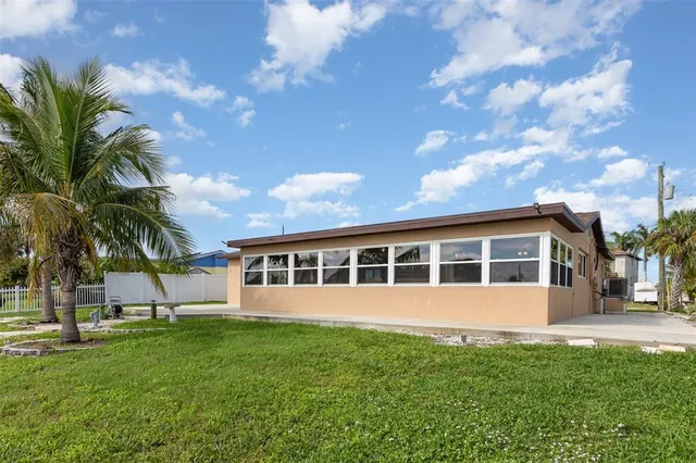 a view of a house with a backyard