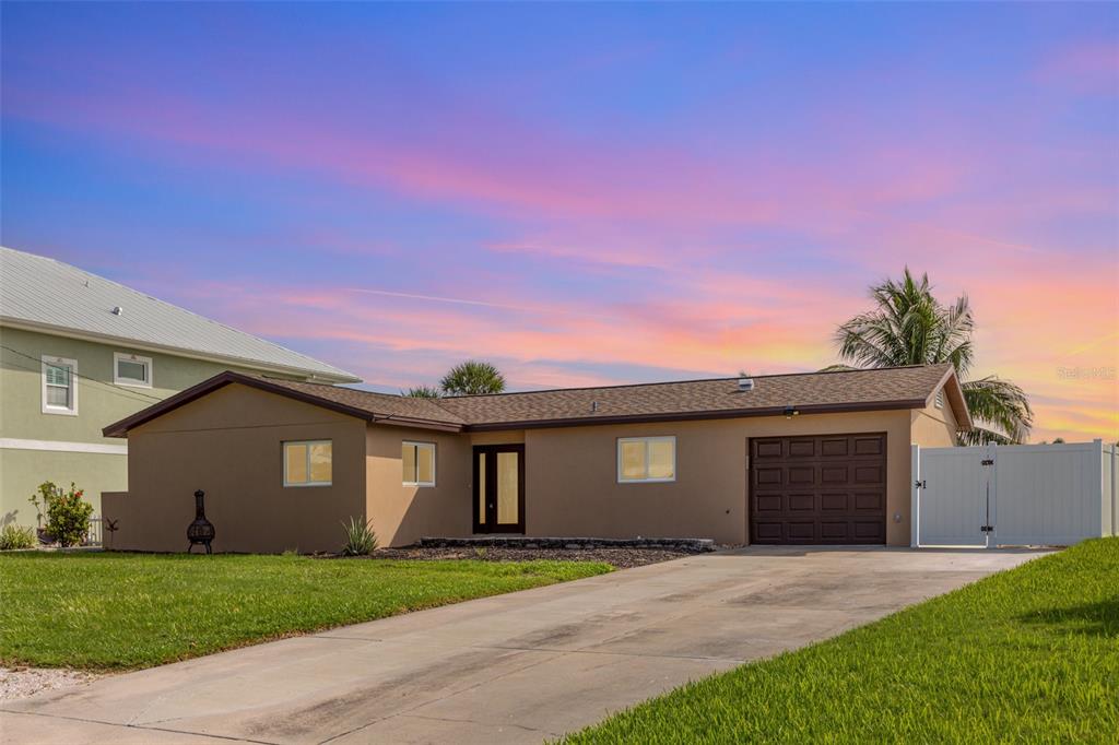 5108 Commonwealth Road Palmetto, FL 34221 - Photo 2 of 31 a front view of a house with a yard and garage