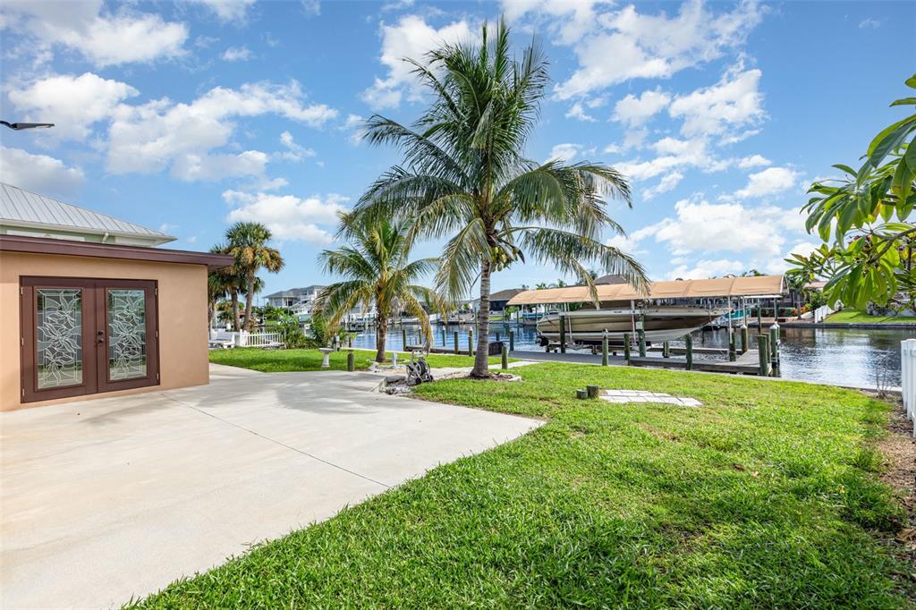 5108 Commonwealth Road Palmetto, FL 34221 - Photo 22 of 31 a view of a swimming pool with a yard and palm trees