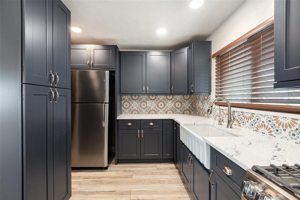 5108 Commonwealth Road Palmetto, FL 34221 - Photo 8 of 31 a kitchen with stainless steel appliances granite countertop a refrigerator and a sink