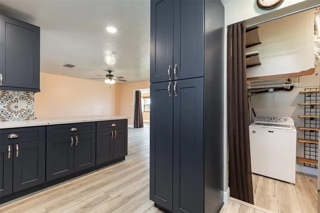 a kitchen with a refrigerator and cabinets