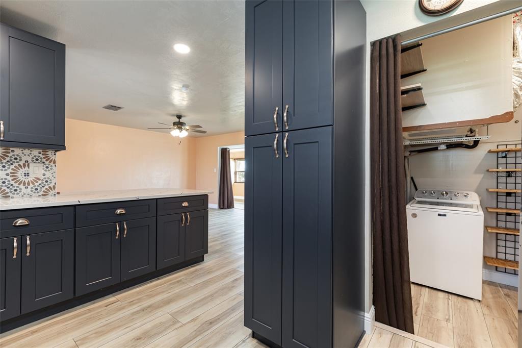 5108 Commonwealth Road Palmetto, FL 34221 - Photo 10 of 31 a kitchen with a refrigerator and cabinets