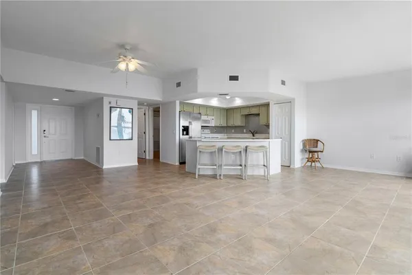 a view of an empty room with a kitchen