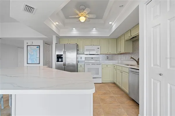 a kitchen with kitchen island a sink stainless steel appliances and cabinets