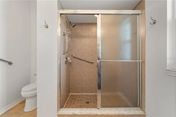 a bathroom with a glass shower door
