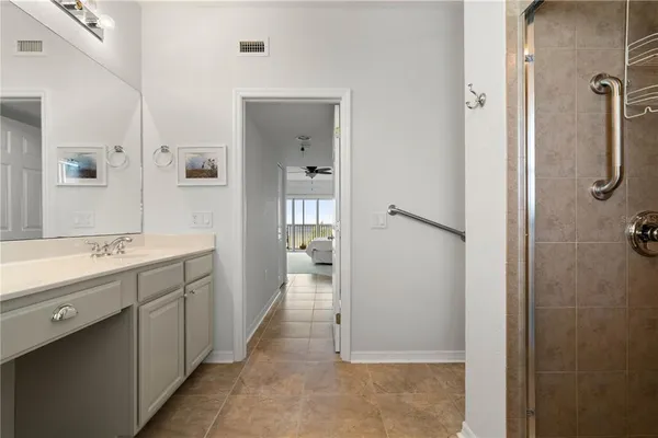 a bathroom with a double vanity sink a toilet and shower