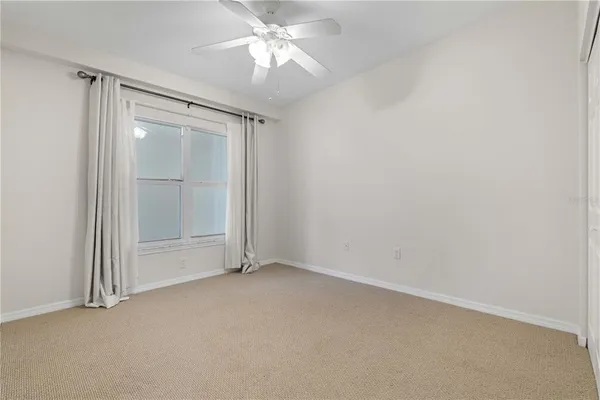 an empty room with a empty space and a ceiling fan