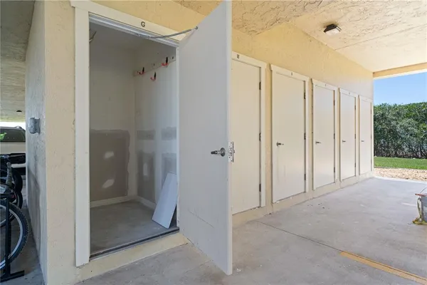 a view of a house with a yard and lawn chairs