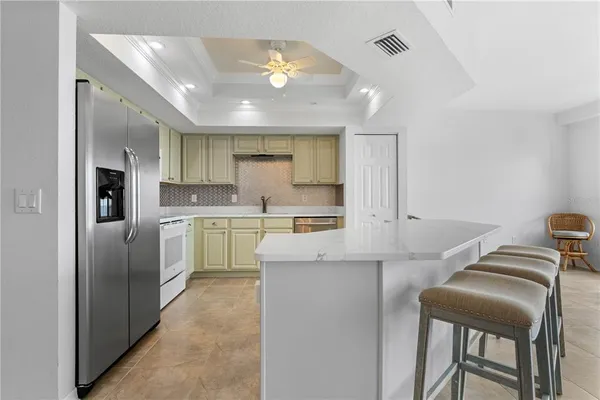 a kitchen with cabinets and refrigerator