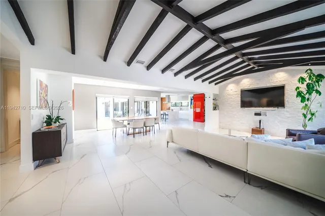a living room with furniture and flat screen tv