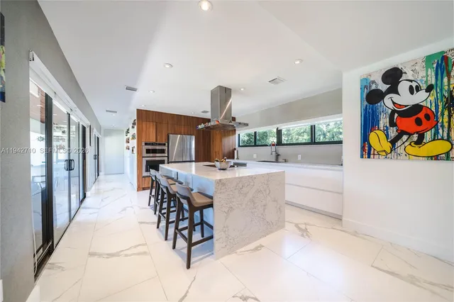 a dining hall with couches and chandelier