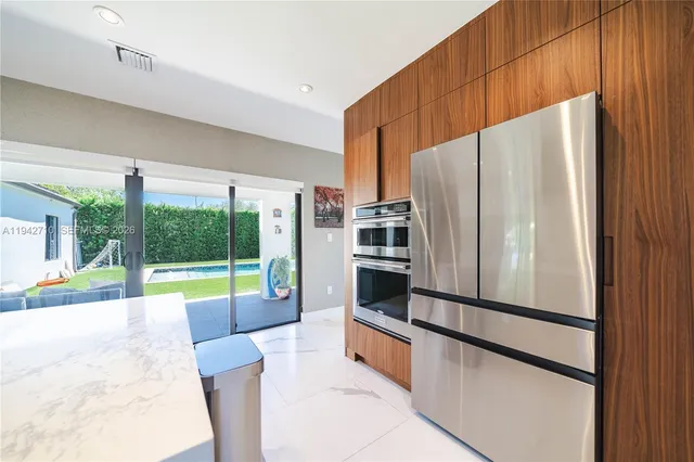 a kitchen with stainless steel appliances a refrigerator and a sink