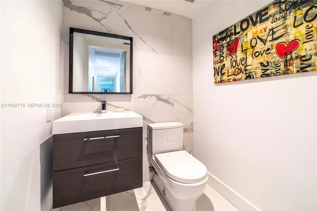 a bedroom with a bed a table and a dresser