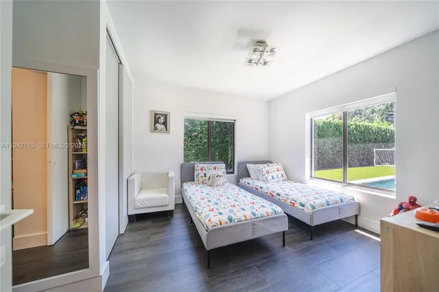 a bathroom with double vanity sink and a mirror