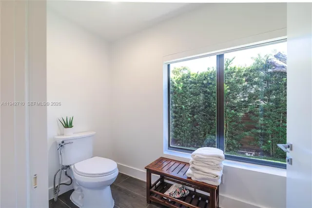 a bedroom with a large bed and wooden floor