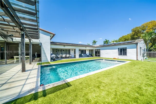 a view of a backyard with sitting area