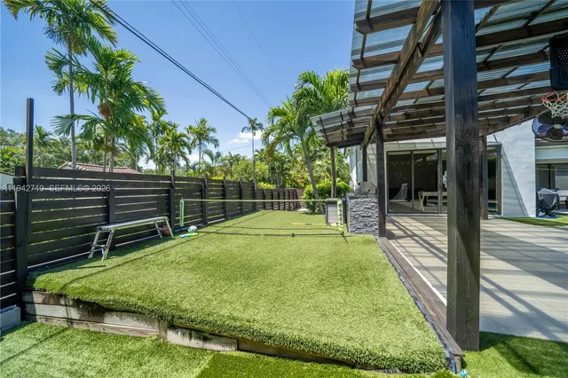 a view of a backyard with a patio and a tub