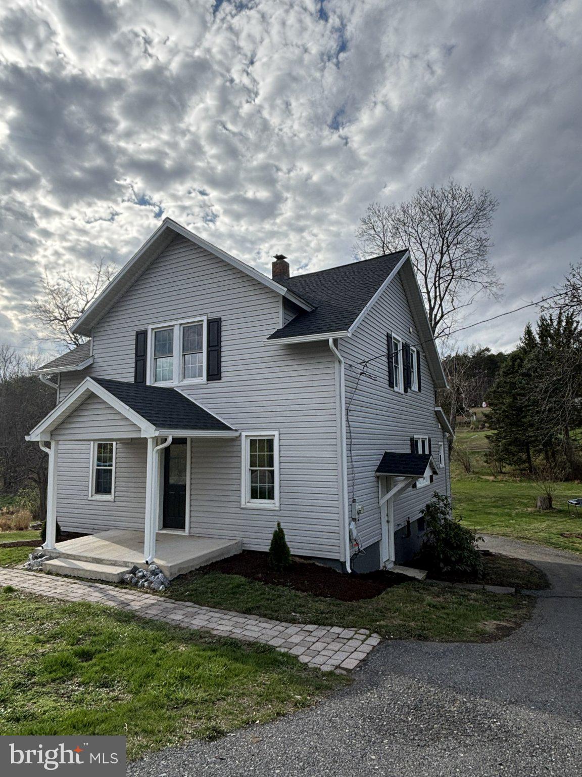 Charming home under a cloudy sky.