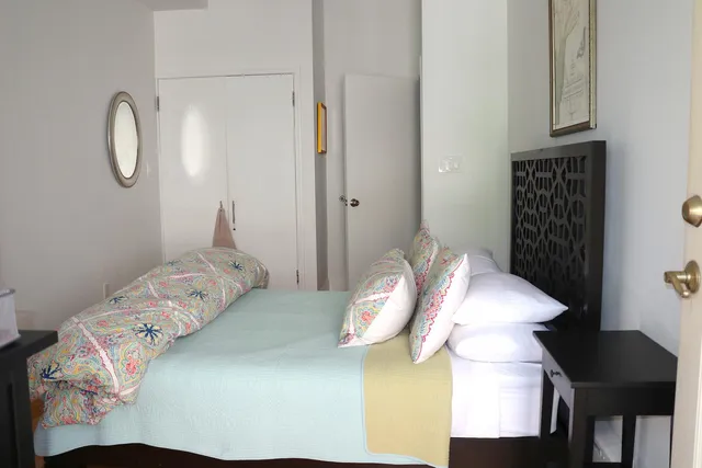 a bedroom with a bed and cabinets