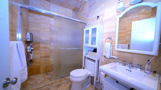 a bathroom with a sink toilet and shower