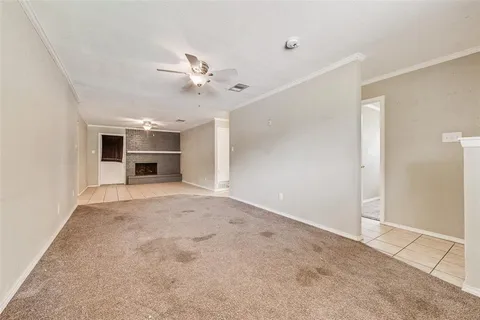 a view of a livingroom with a ceiling fan and a window