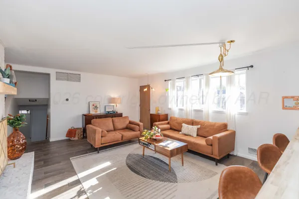 a living room with furniture a lamp and a window