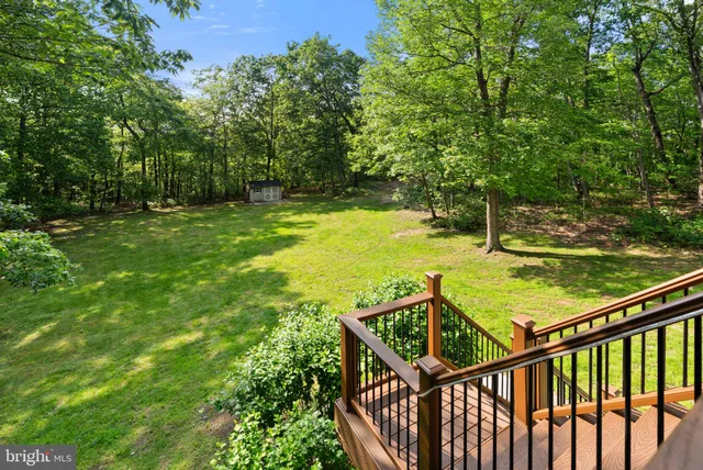 a kitchen with stainless steel appliances granite countertop a refrigerator stove microwave and wooden floor