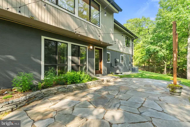 a spacious bathroom with a toilet sink and mirror