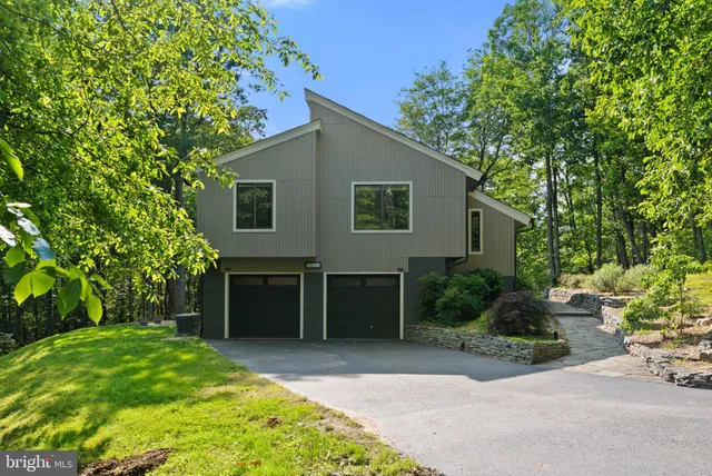 a kitchen with stainless steel appliances granite countertop a kitchen island a stove a refrigerator and a sink