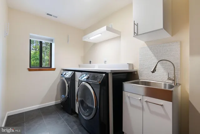 a stove top oven sitting inside of a kitchen