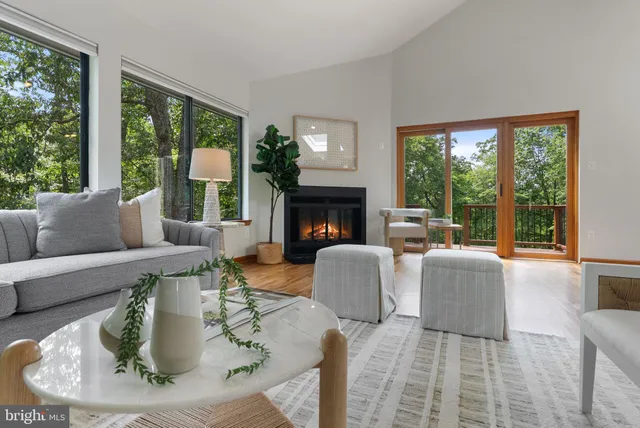 a dining room with furniture a large window and a chandelier
