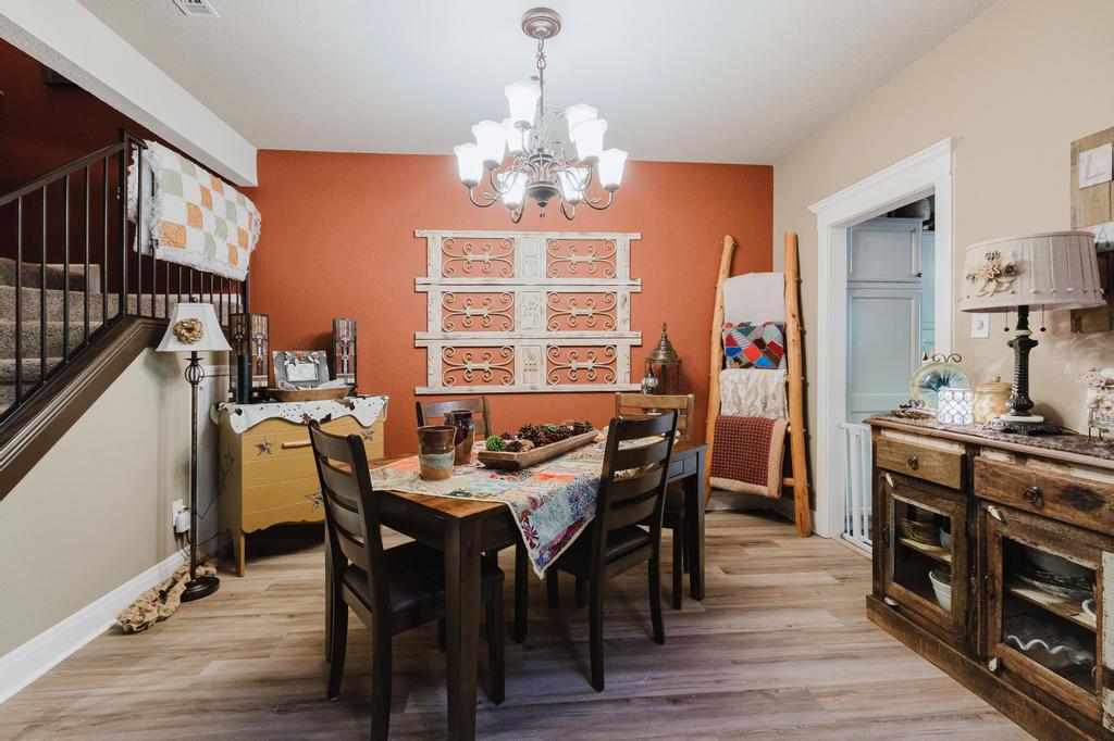 10819 Crown Colony Drive, Unit 40 Austin, TX 78747 - Photo 11 of 38 Dining room featuring a chandelier, light wood-style flooring, and stairway