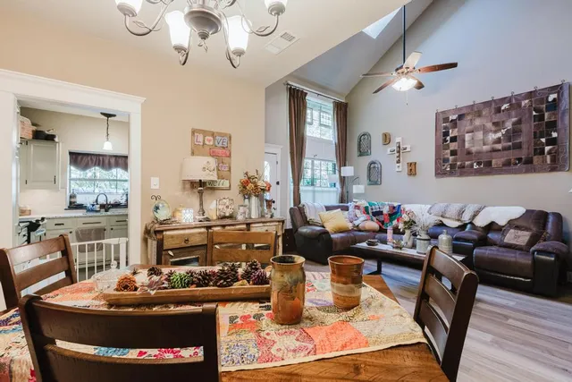 a living room with furniture and a chandelier