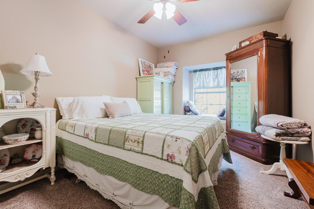 10819 Crown Colony Drive, Unit 40 Austin, TX 78747 - Photo 16 of 38 Bedroom featuring carpet floors and a ceiling fan