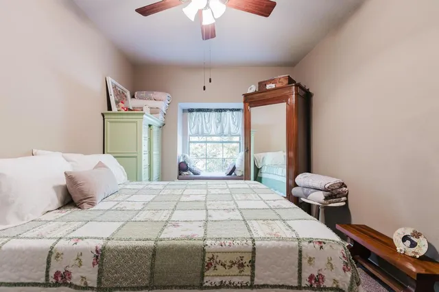 a bedroom with a bed and a chandelier
