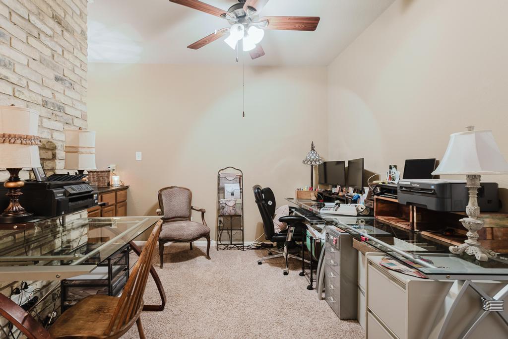 10819 Crown Colony Drive, Unit 40 Austin, TX 78747 - Photo 22 of 38 Office area with light carpet and ceiling fan