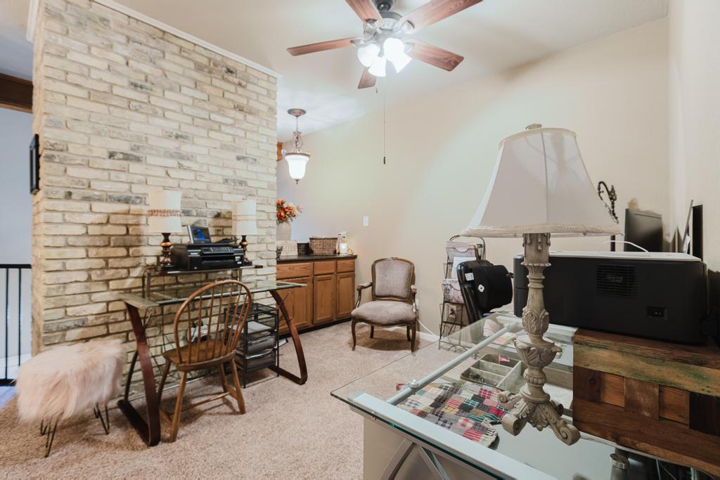 10819 Crown Colony Drive, Unit 40 Austin, TX 78747 - Photo 23 of 38 Home office with light colored carpet and ceiling fan