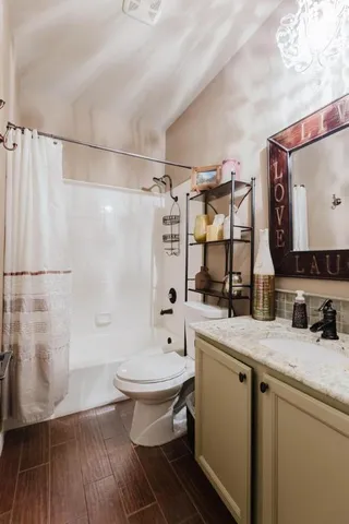 a bathroom with a sink toilet a mirror and shower