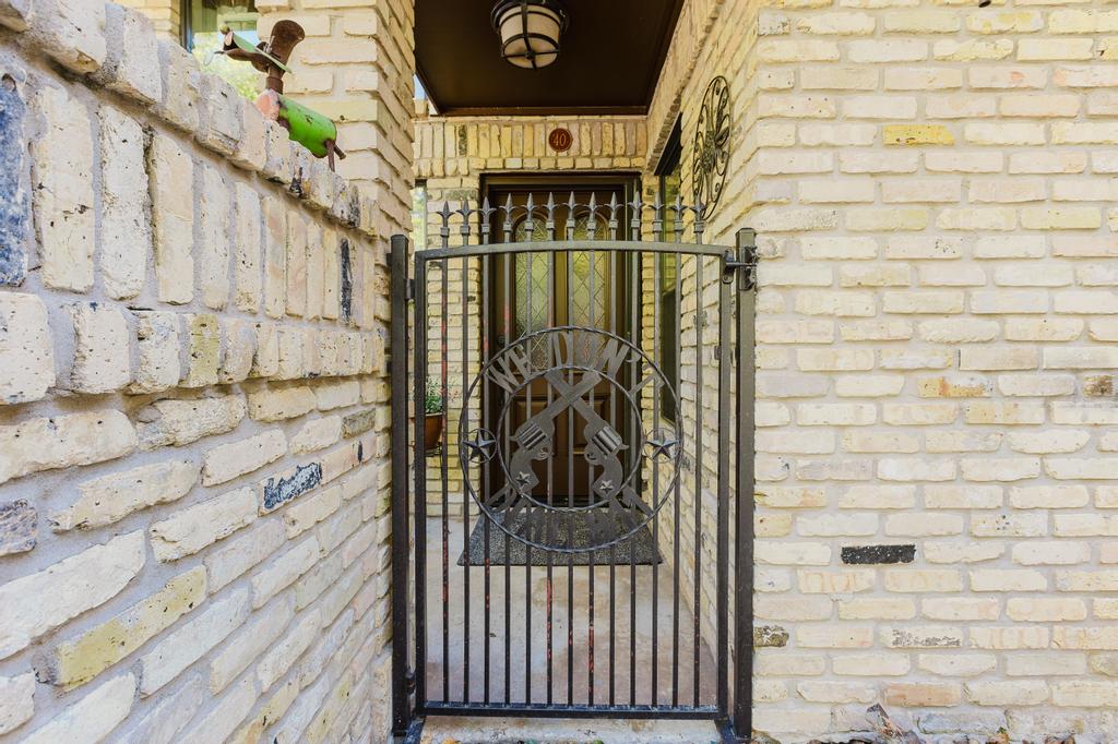 10819 Crown Colony Drive, Unit 40 Austin, TX 78747 - Photo 4 of 38 Entrance to property with a gate and brick siding