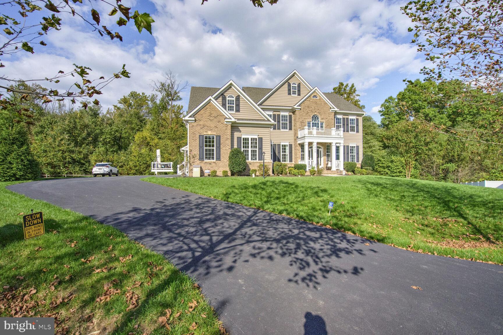 800 Lower Barn Way Olney, MD 20832 - Photo 40 of 45 a view of a white house next to a yard with big trees