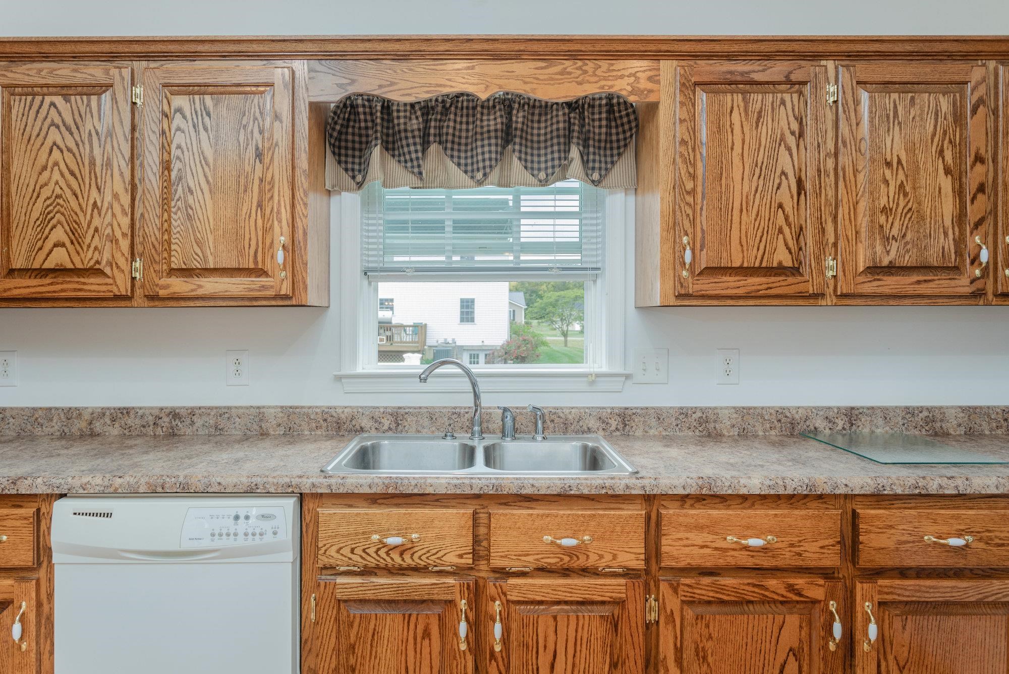490 Leola Loop Stanley, VA 22851 - Photo 11 of 44 a kitchen with granite countertop a sink and cabinets