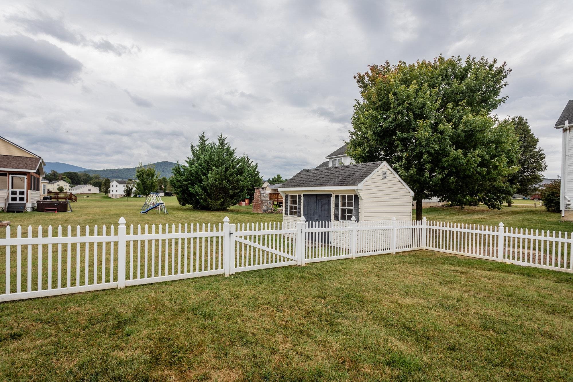 490 Leola Loop Stanley, VA 22851 - Photo 43 of 44 a view of a house with a fence and trees