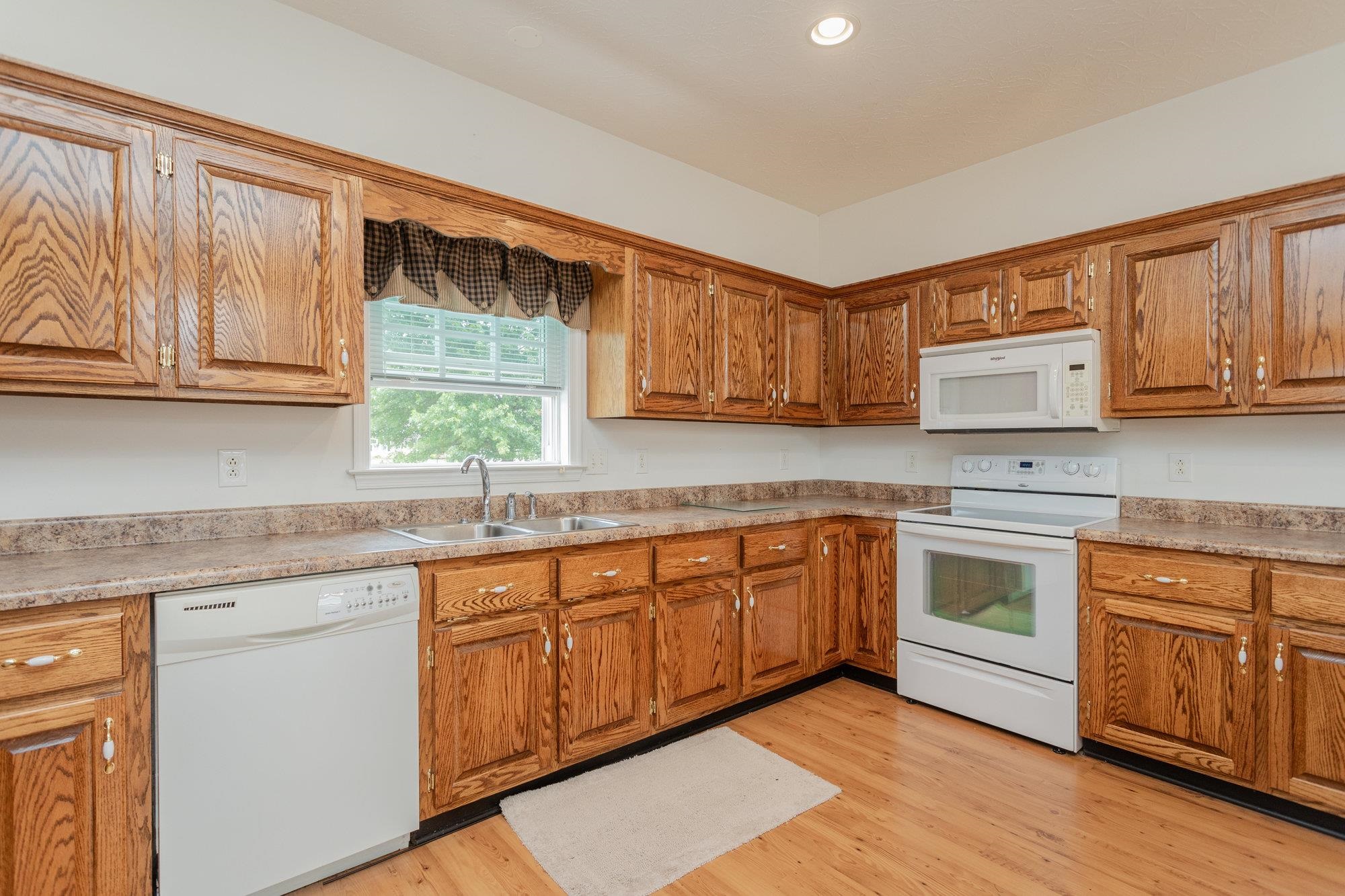 490 Leola Loop Stanley, VA 22851 - Photo 8 of 44 a kitchen with stainless steel appliances granite countertop wooden cabinets a sink and a stove