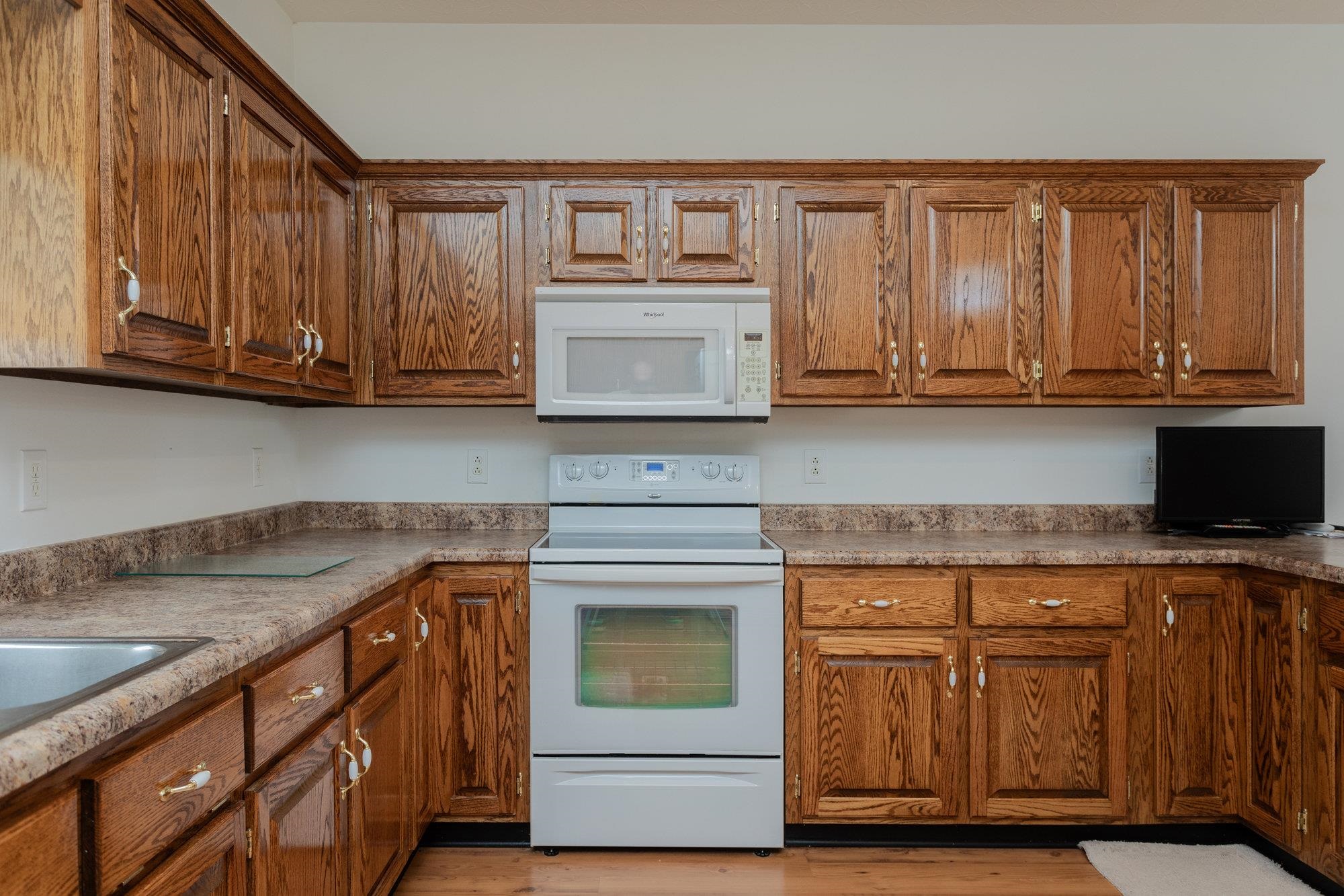 490 Leola Loop Stanley, VA 22851 - Photo 9 of 44 a kitchen with granite countertop cabinets stainless steel appliances and wooden cabinets