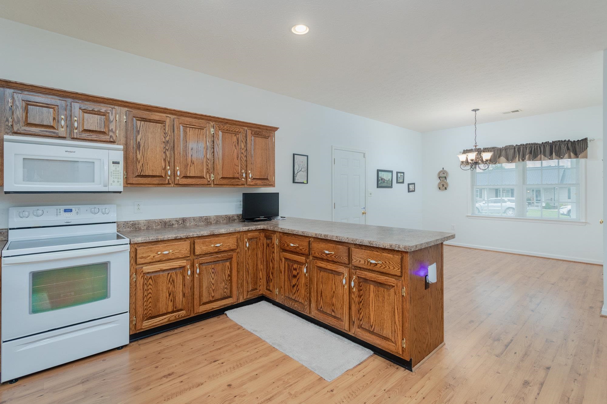 490 Leola Loop Stanley, VA 22851 - Photo 10 of 44 a kitchen with stainless steel appliances granite countertop a stove a sink and a microwave oven with cabinets
