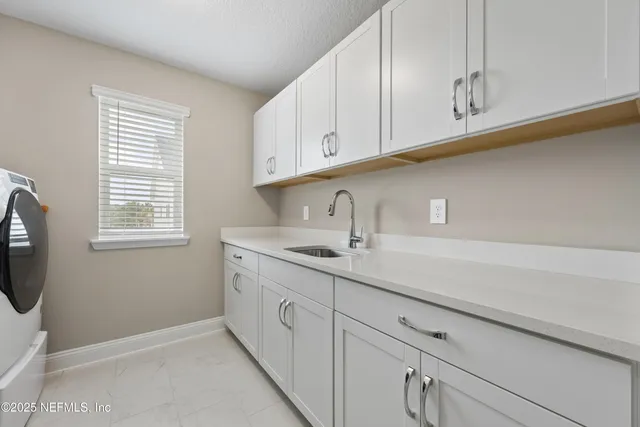 a kitchen with appliances cabinets and a window