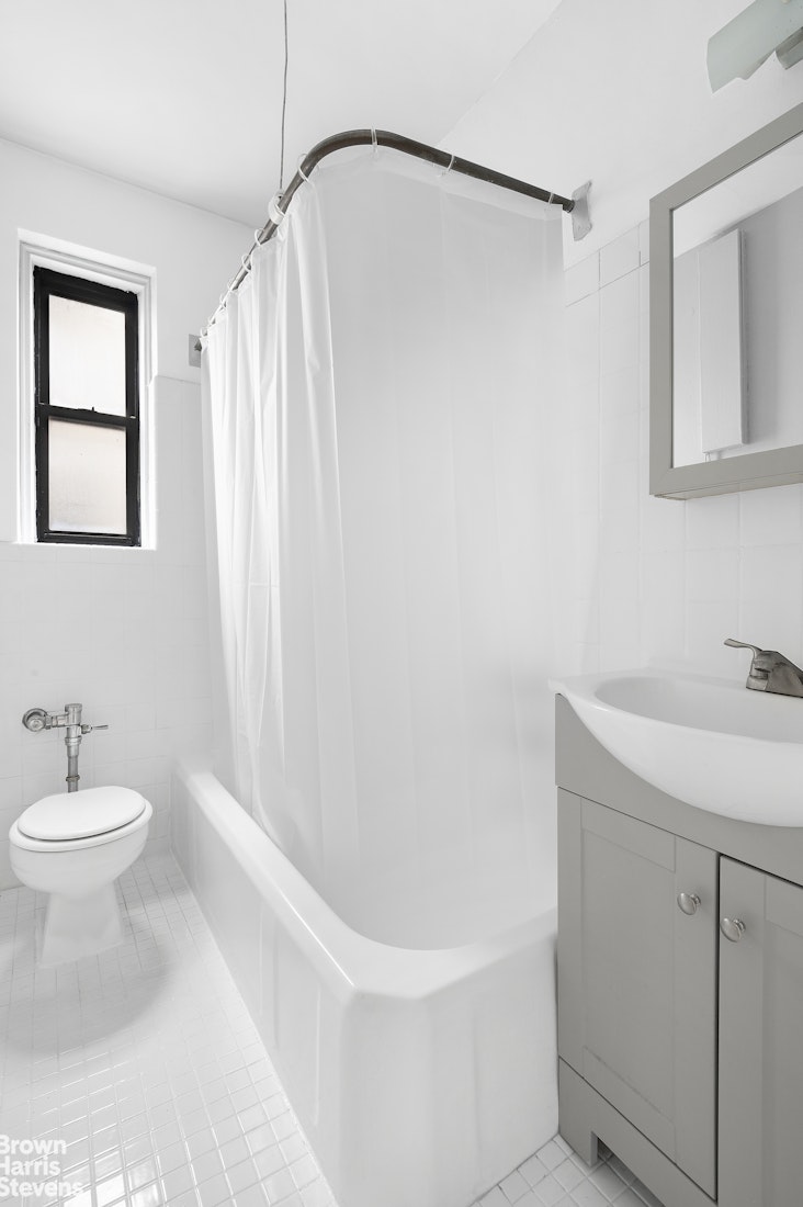 55 East 190th Street, Unit 41 Bronx, NY 10468 - Photo 5 of 8 a bathroom with a sink a toilet and shower