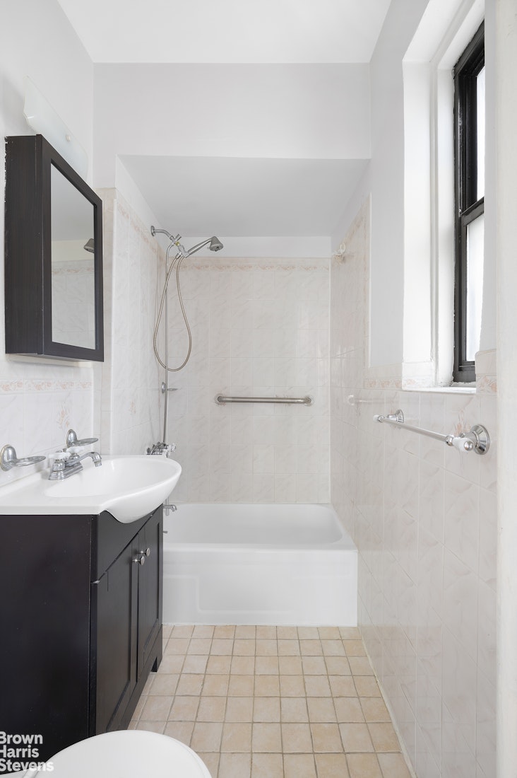55 East 190th Street, Unit 41 Bronx, NY 10468 - Photo 6 of 8 a bathroom with a sink a toilet and shower